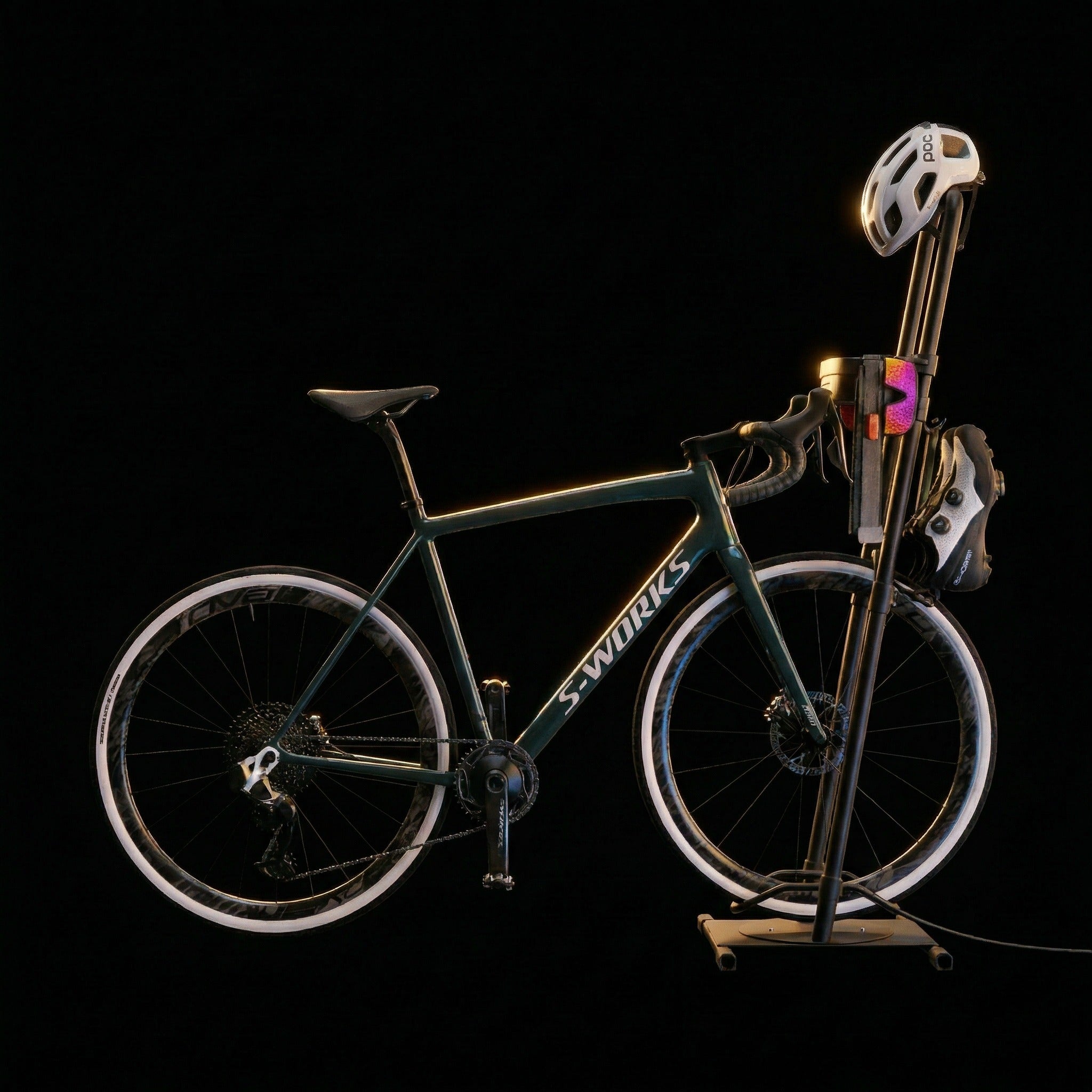 Ready Rack bike storage rack holding a teal Specialized S-Works road bike, with a white POC helmet on the mount, colorful cycling glasses and shoes organized on the rack, shot against a clean black background.