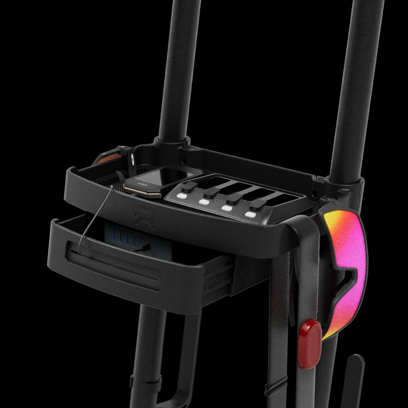 Close-up of the Ready Rack accessory shelf with the power drawer pulled open revealing USB charging ports, a bike computer and glasses on the tray, and a colorful pair of cycling glasses hanging from the side, shown against a black background.